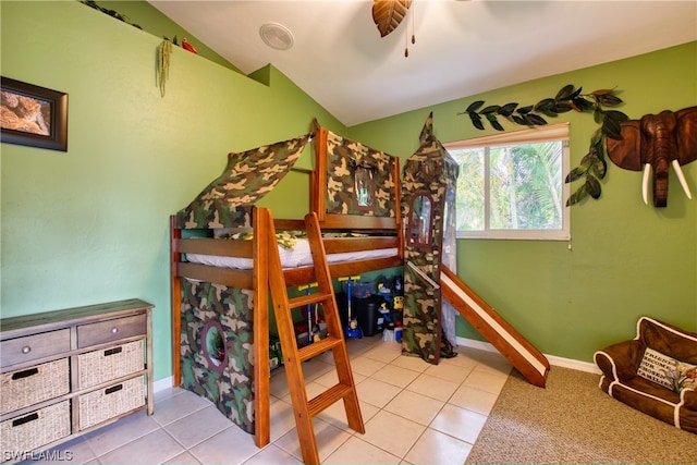 bedroom with light tile flooring, vaulted ceiling, and ceiling fan