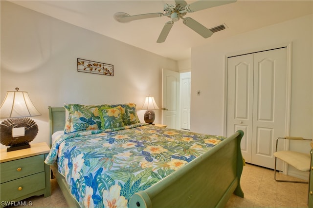 tiled bedroom with a closet and ceiling fan