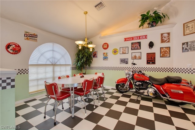 tiled dining space with vaulted ceiling