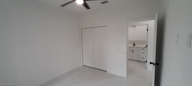 unfurnished bedroom featuring sink, ceiling fan, and light tile flooring