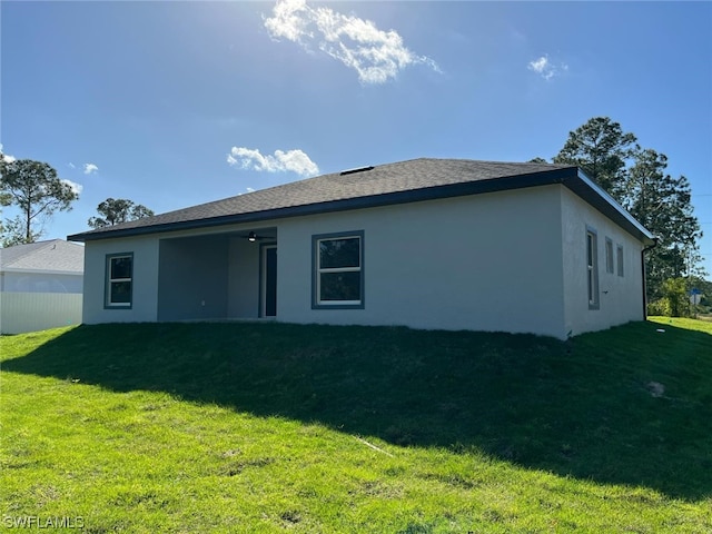 back of property featuring a lawn