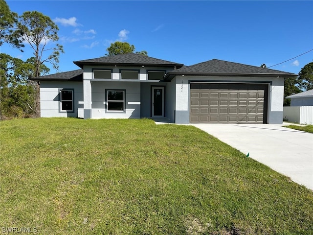 view of front of home with a front yard and a garage