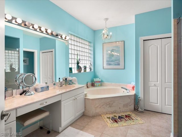 bathroom featuring a bath, vanity with extensive cabinet space, tile flooring, and a notable chandelier