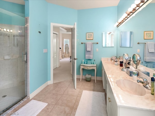 bathroom featuring double sink vanity, a shower with door, and tile flooring