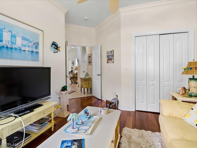 living room with crown molding, ceiling fan, and dark hardwood / wood-style flooring