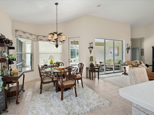 tiled dining area featuring an inviting chandelier and plenty of natural light