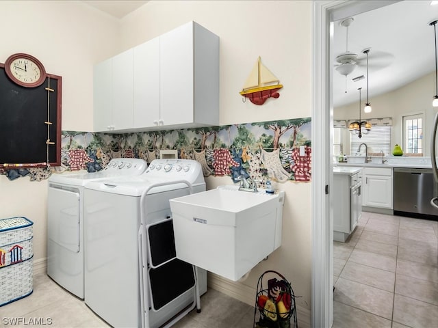 washroom featuring light tile floors, washer and clothes dryer, ceiling fan with notable chandelier, and sink