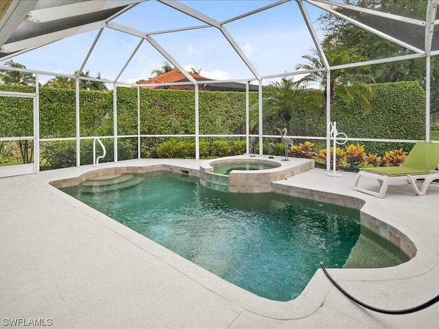 view of swimming pool featuring an in ground hot tub, a lanai, and a patio