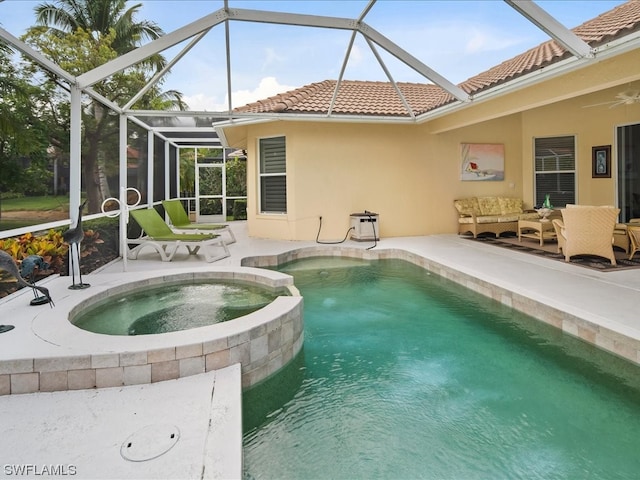 view of pool with a patio, an in ground hot tub, and glass enclosure