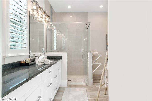 full bath with wood tiled floor, vanity, recessed lighting, and a shower stall