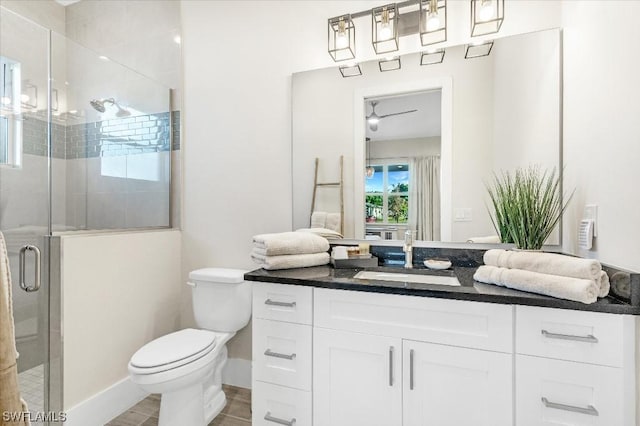 full bath featuring a shower stall, baseboards, toilet, vanity, and a ceiling fan