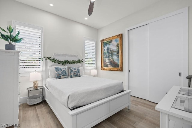 bedroom with recessed lighting, multiple windows, and light wood-style floors