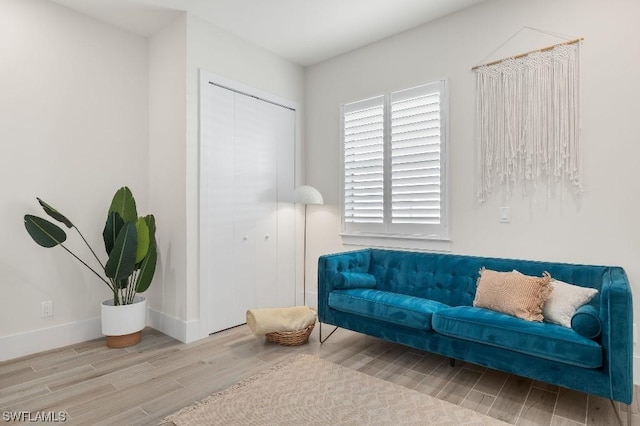 sitting room featuring baseboards and wood tiled floor