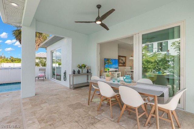 view of patio / terrace with outdoor dining area, a fenced in pool, a ceiling fan, and fence