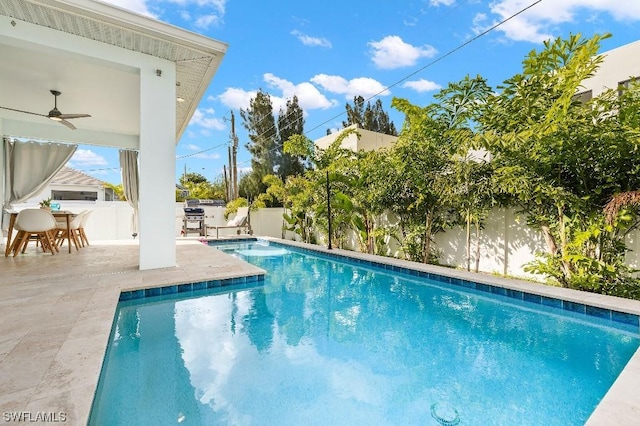 view of pool featuring a fenced in pool, a patio, a fenced backyard, and a ceiling fan