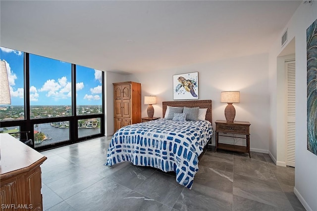 bedroom with floor to ceiling windows