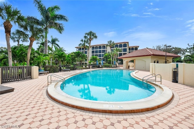 6040 Pelican Bay Blvd Unit D-105, Naples, FL 34108 - view of swimming pool with a patio