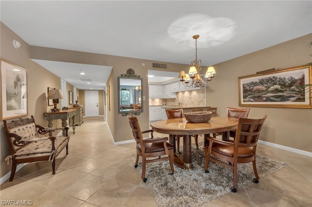 6040 Pelican Bay Blvd Unit D-105, Naples, FL 34108 - dining room with light tile floors and a chandelier