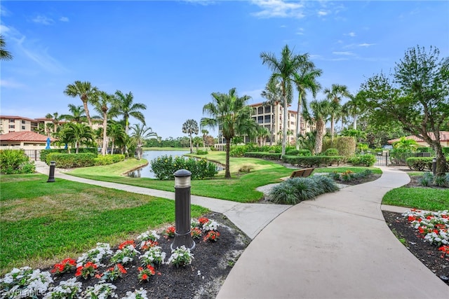 6040 Pelican Bay Blvd Unit D-105, Naples, FL 34108 - view of property's community featuring a water view and a lawn