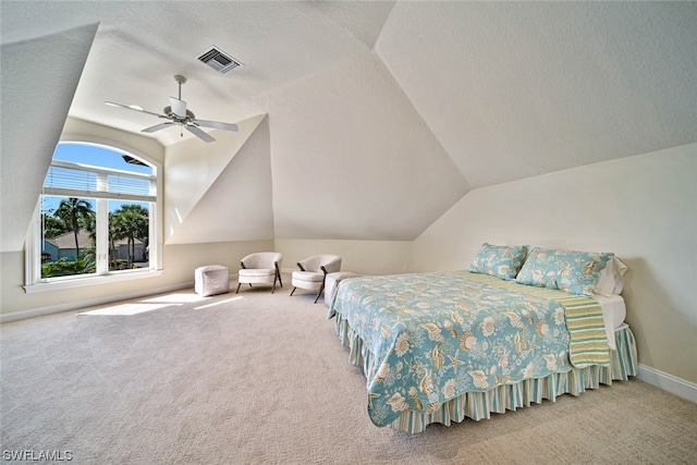 bedroom featuring vaulted ceiling, ceiling fan, carpet flooring, and a textured ceiling