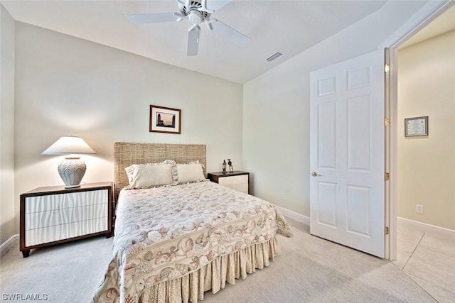 bedroom featuring light carpet, baseboards, visible vents, and a ceiling fan