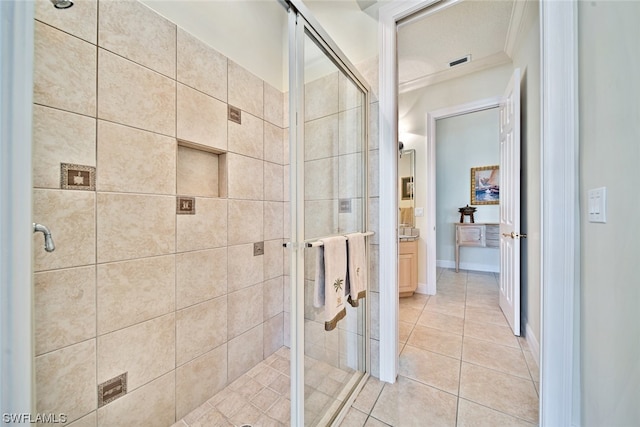 bathroom featuring crown molding, tile patterned flooring, and an enclosed shower