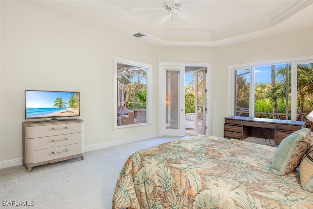 carpeted bedroom with a tray ceiling, ceiling fan, ensuite bathroom, and crown molding