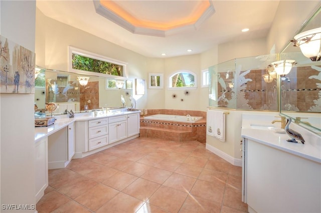 bathroom featuring tile patterned floors, tiled shower, vanity, a raised ceiling, and a bath