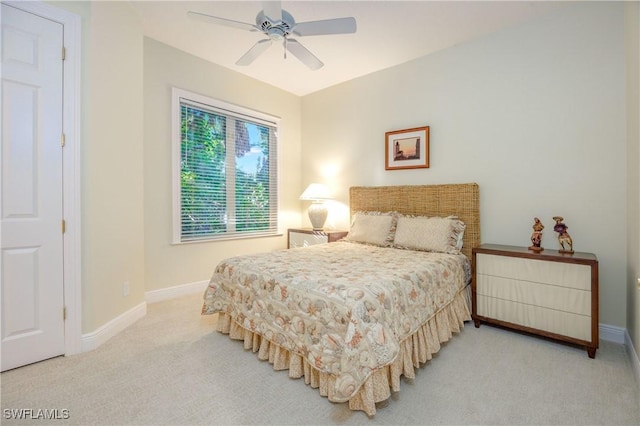 bedroom with a ceiling fan, carpet floors, and baseboards