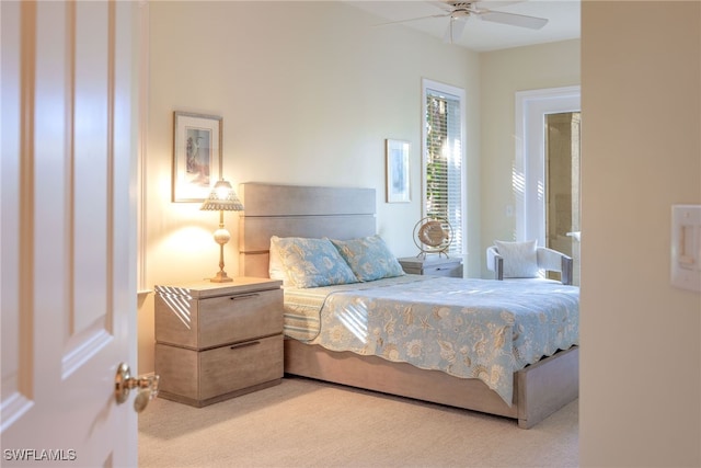 bedroom with light carpet and ceiling fan