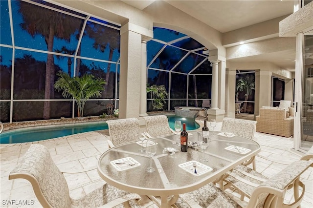 pool with a patio, outdoor dining space, and a lanai