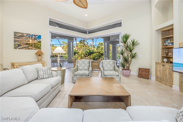 living room with ceiling fan, light tile patterned flooring, and built in features