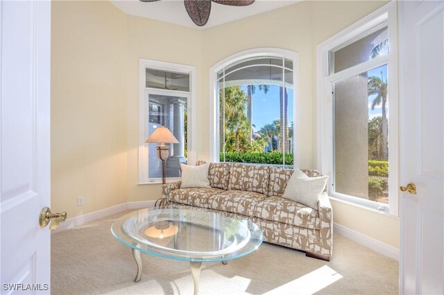 living room featuring ceiling fan, plenty of natural light, and carpet flooring