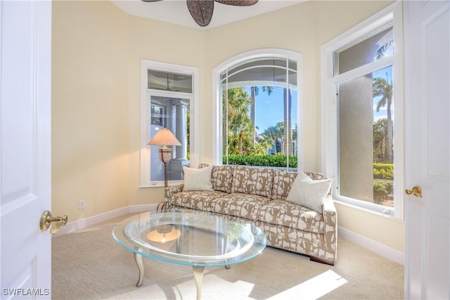 interior space featuring baseboards and ceiling fan