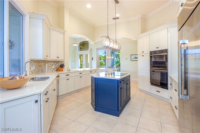 kitchen with crown molding, light tile patterned flooring, black appliances, and a sink