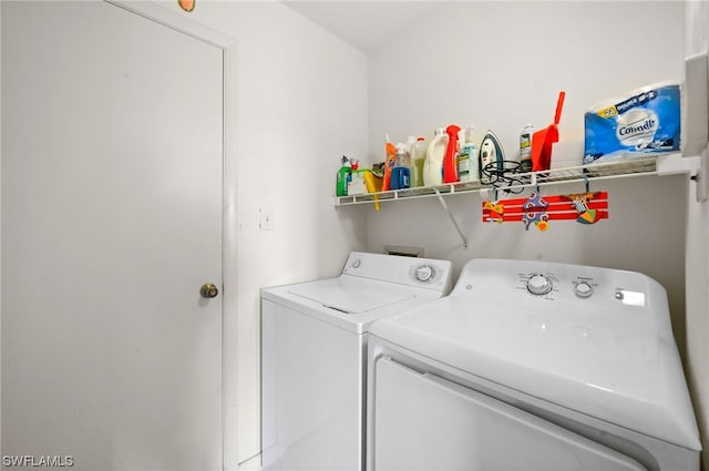 clothes washing area featuring independent washer and dryer