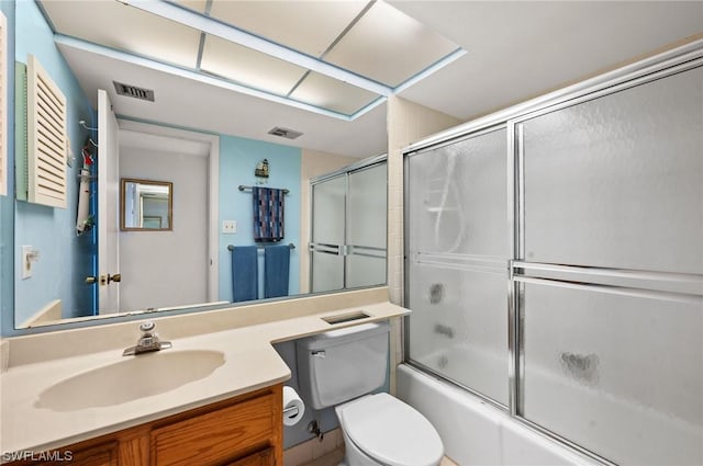 full bath with toilet, bath / shower combo with glass door, vanity, and visible vents