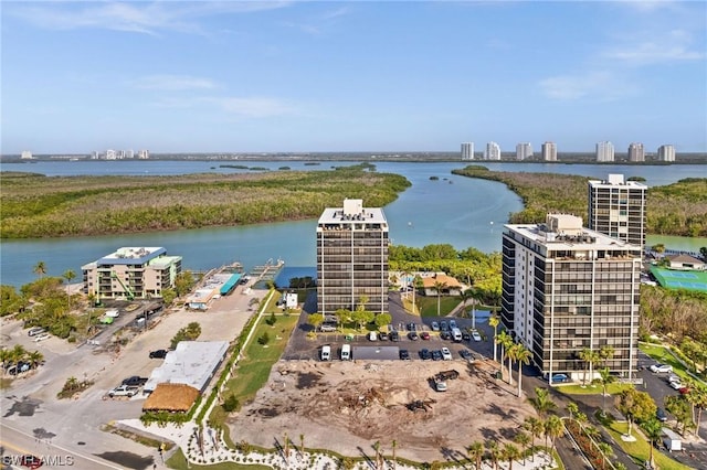 drone / aerial view featuring a water view and a view of city