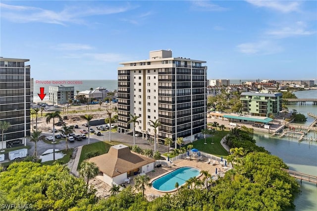 view of building exterior with a water view and a city view