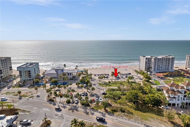 bird's eye view with a water view and a beach view