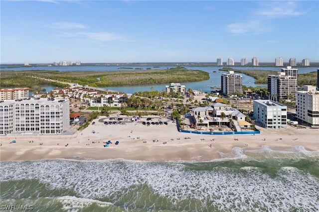 drone / aerial view featuring a water view and a beach view