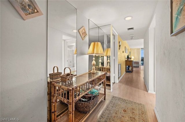 corridor with light hardwood / wood-style flooring