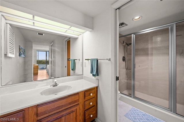 bathroom featuring vanity and an enclosed shower