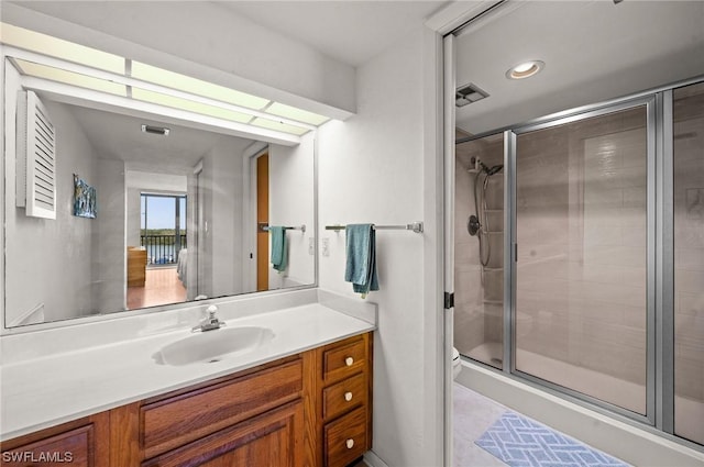 full bath with a shower stall, visible vents, vanity, and toilet