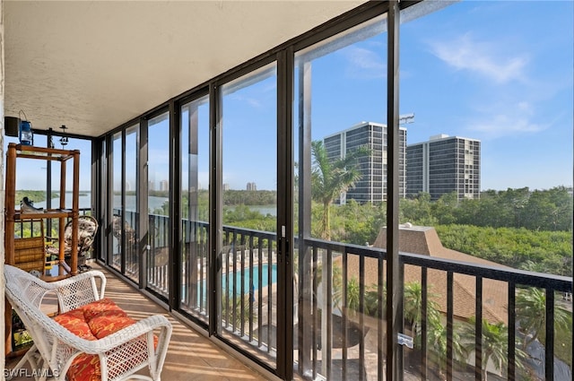 unfurnished sunroom featuring a water view and a healthy amount of sunlight