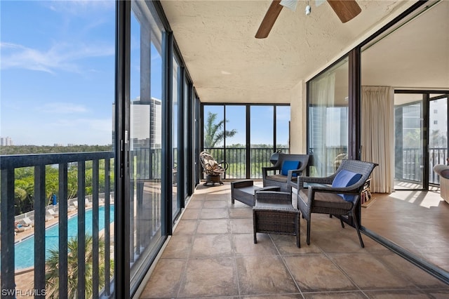 sunroom featuring ceiling fan