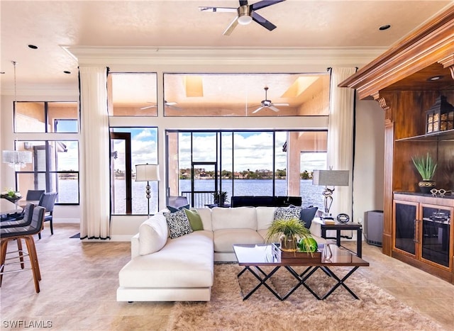 living room featuring ornamental molding and ceiling fan