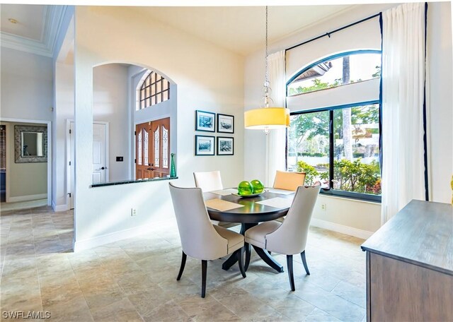 dining space with crown molding