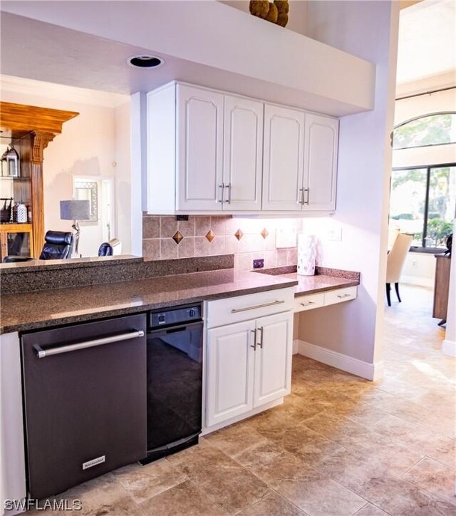 kitchen with stainless steel dishwasher, white cabinets, and decorative backsplash