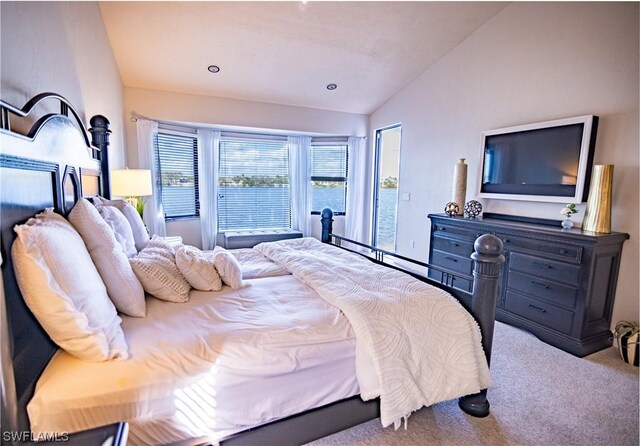 bedroom featuring carpet and vaulted ceiling